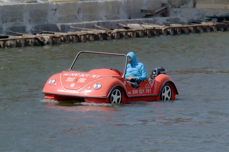 15 - Custom motorized rental boat styled like a classic VW Beetle car, cruising down the Motława River in Gdańsk, Poland
